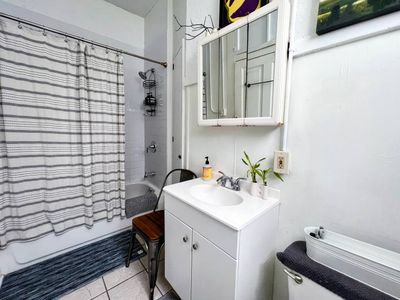 Bathroom w/ a tub/shower combo & a sink for a refreshing start to your day.