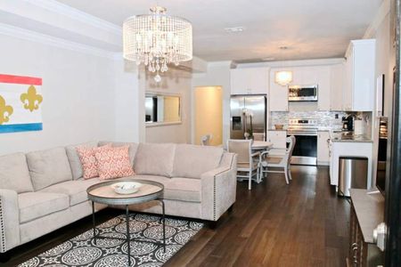 Open-concept living, dining & kitchen area bathed in warm light.