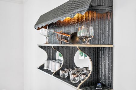 Elegant bar nook w/ wine & cocktail glasses ready for entertaining.
