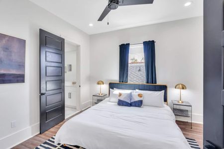 Upstairs king bedroom w/ en-suite bath, warm wood tones & cozy layered linens.