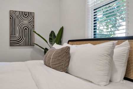 Soft pillows & a woven headboard set the scene for slow, lazy mornings