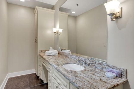 Granite vanity with elegant sconce lighting