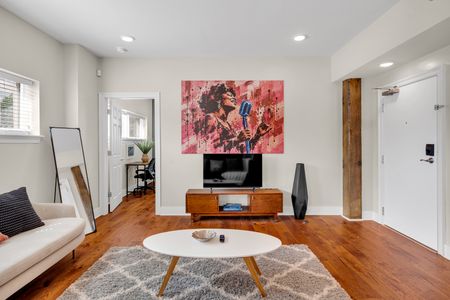 Jazz-inspired art above a warm wood media console