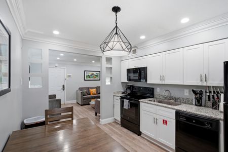Stylish kitchen w/ sleek finishes & a dining nook to enjoy every meal.
