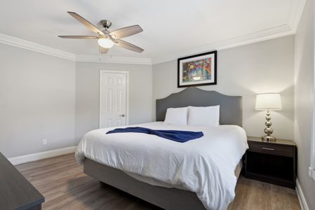 Serene primary bedroom w/ a plush bed & plenty of natural light.