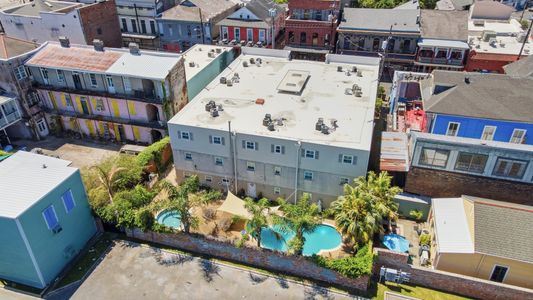 Bird's-eye view of the pool & hot tub framed by the city skyline.