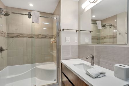 Glass shower with sleek tile finishes