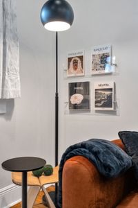 Curated gallery wall & soft lamp light make a cozy corner to unwind