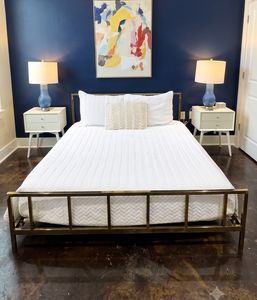 Bright bedroom w/ blue accent wall & fresh white bedding