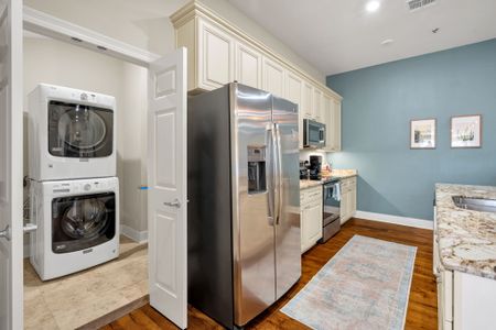 Stainless kitchen with laundry tucked nearby