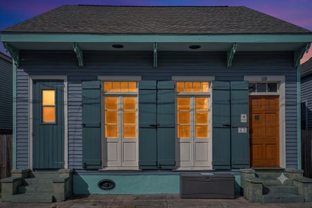 Classic New Orleans façade w/ signature shuttered doors & timeless curb appeal.