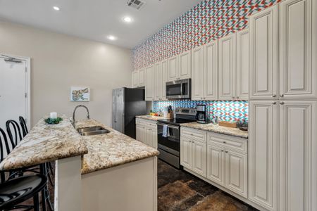 Colorful geometric backsplash in a chef-ready kitchen