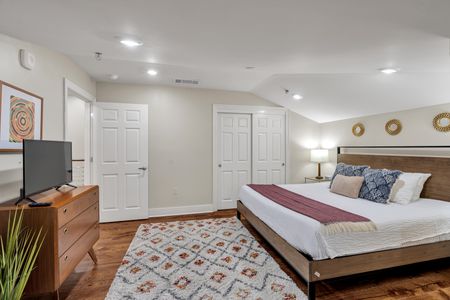 Roomy bedroom with double closets and rug
