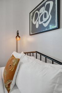Curl up w/ a book under the warm glow of the wall lamp in this cozy bedroom nook