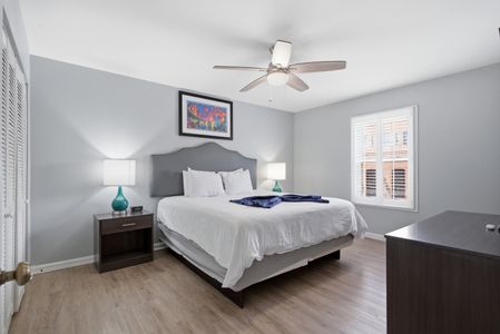 Serene primary bedroom w/ a king bed & crisp white linens for a restful night's sleep.