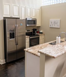 Fully equipped kitchen with stainless steel appliances and generous counter space