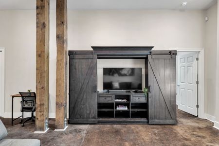 Barn door media cabinet with a Smart TV