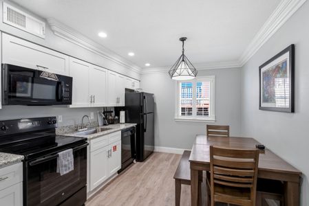 Fully equipped kitchen w/ modern appliances & a dining area to gather.