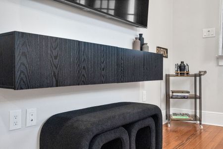 Settle in for movie night by the wall-mounted TV w/ a sleek wood-grain console & cozy curved seating