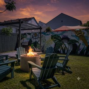 Backyard vibes w/ a firepit, colorful mural, & seating — your crew's favorite hangout spot.