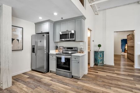 Gray shaker kitchen with full-size fridge