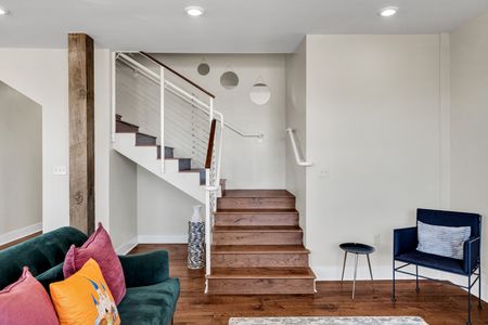 Staircase view down to the art-filled living area