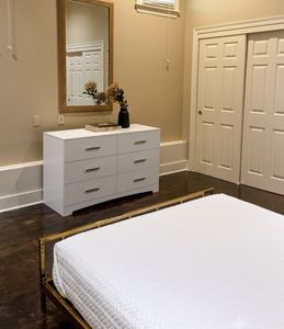 Bedroom with dresser and convenient storage space