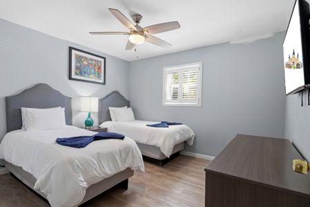Unit 205 secondary bedroom w/ twin beds & a calm, neutral palette.