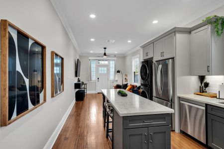Chat over the island while dinner cooks in this open-concept kitchen w/ in-unit washer & dryer
