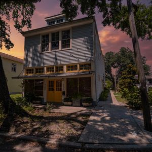 Sun-soaked building exterior nestled in a lively neighborhood.