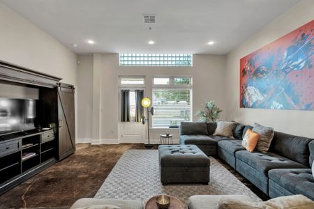 Spacious living with tall windows and natural light