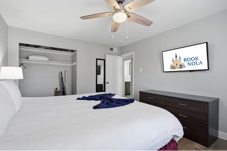 Bright primary suite w/ a plush bed & plenty of room to breathe.