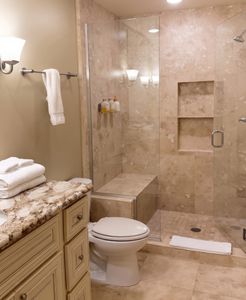 Bathroom w/ granite vanity, sink & glass shower
