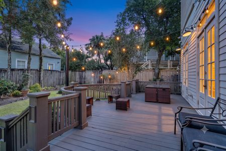 Spacious deck w/ string lights & lounge seating — perfect for evening gatherings under the trees.