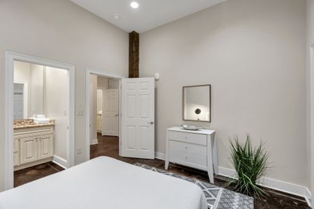 Bright bedroom with a white dresser and plants