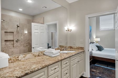 Bright vanity with a view of the bedroom