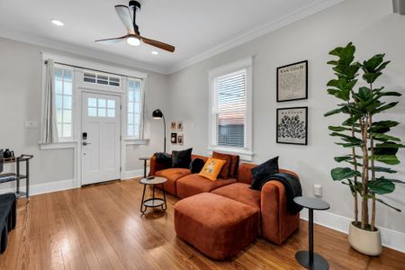 Sink into the cozy sectional surrounded by a curated gallery wall & sunny front windows