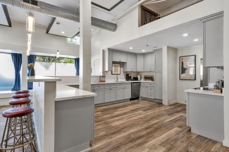 Open kitchen with a quartz peninsula