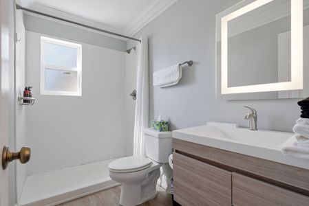 Unit 203 bathroom w/ minimal, clean design & a fresh, simple appeal.