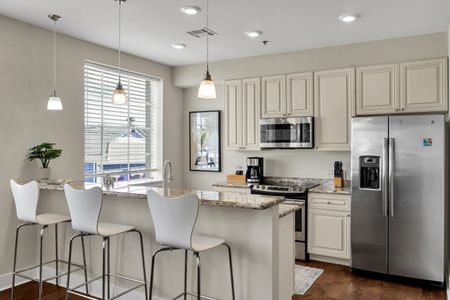 Sunny kitchen with pendant lighting and window views