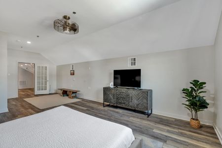 Upstairs bedroom with TV and cozy rug