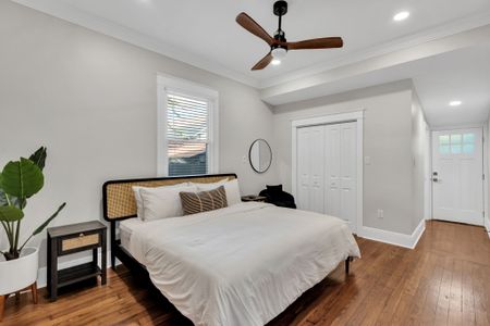Rest easy in this calm bedroom w/ a woven headboard, crisp linens & a handy closet
