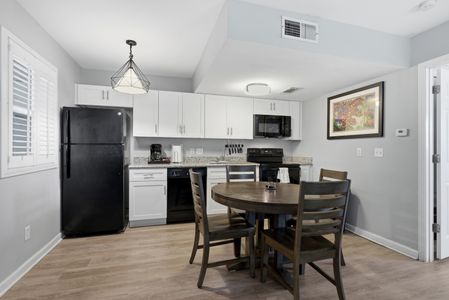 Unit 304 – Fully equipped kitchen w/ dining area, ready for home-cooked meals.