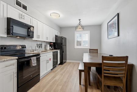 Unit 303 – Sleek kitchen & dining area ready for home-cooked meals together.