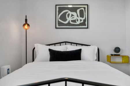 Slip into crisp white linens & a cozy accent pillow for a restful night