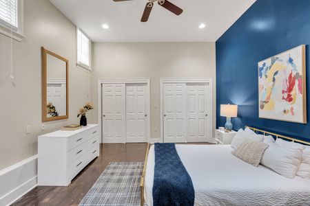 Navy bedroom with dual closets and a dresser