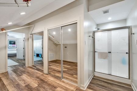 Mirrored closets and a walk-in shower