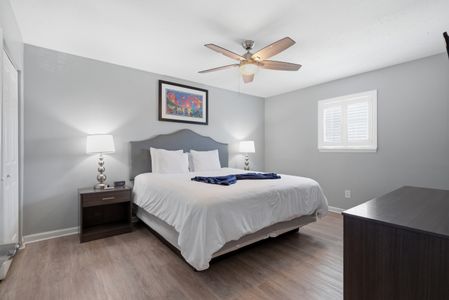 Serene primary bedroom w/ a king bed & calm, restful atmosphere.