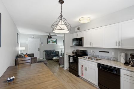 Bright kitchen & dining nook w/ modern pendant lighting — great for casual meals at home.