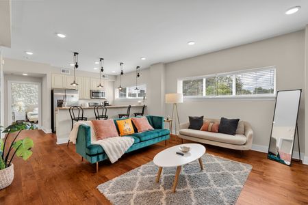 Bright open living under sleek pendant lights
